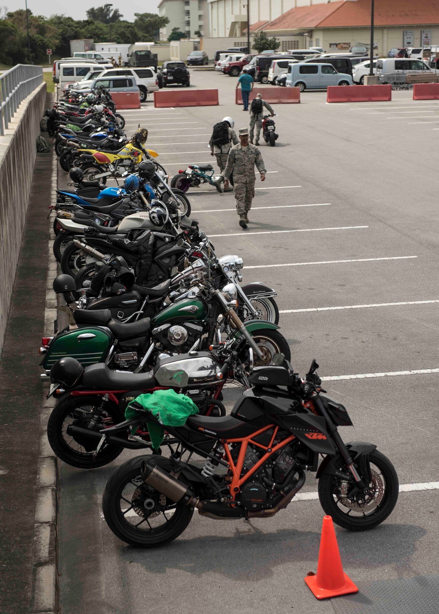 Motorcycles stand in a parking lot during an 18th Wing annual motorcycle safety brief March 9, 2017, at Kadena Air Base, Japan. Wing Safety and the Green Knights chapter 138 briefed riders on all legal requirements and also provided a skills practice course for participants to refresh fundamental and advanced riding techniques. (U.S. Air Force photo by Staff Sgt. Peter Reft/Released)