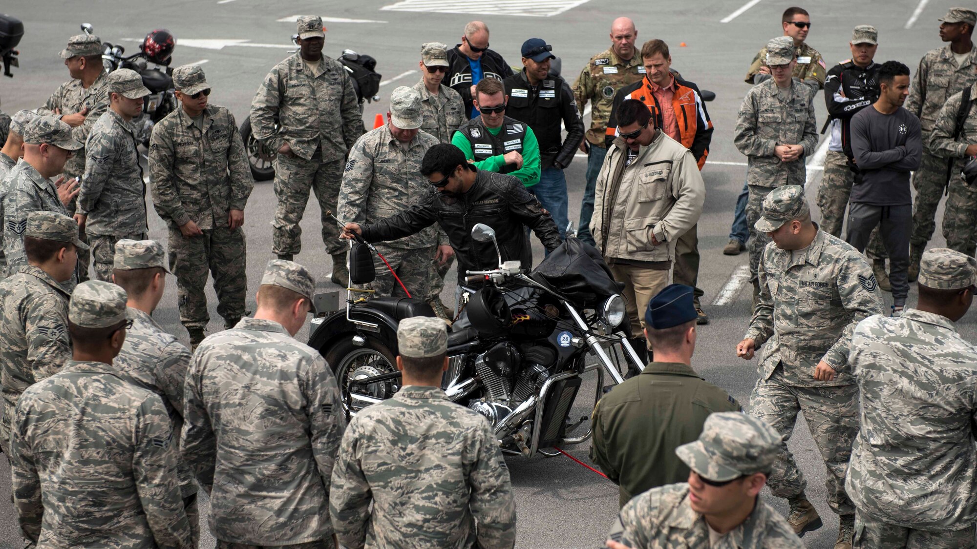 Members of Wing Safety perform a pre-ride inspection checklist with riders during an 18th Wing annual motorcycle safety brief March 9, 2017, at Kadena Air Base, Japan. Wing Safety and the Green Knights chapter 138 reminded riders of their legal responsibilities and also organized a motorcycle skills refresher course. (U.S. Air Force photo by Staff Sgt. Peter Reft/Released)