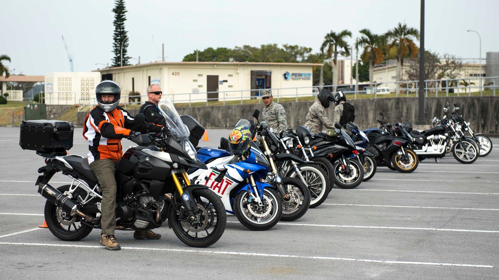 Riders stationed on Okinawa gear up for a motorcycle skills test course during an 18th Wing annual motorcycle safety brief March 9, 2017, at Kadena Air Base, Japan. Wing Safety and the Green Knights chapter 138 organized the event and reinforced safety riding standards for riders stationed on Okinawa. (U.S. Air Force photo by Staff Sgt. Peter Reft/Released)