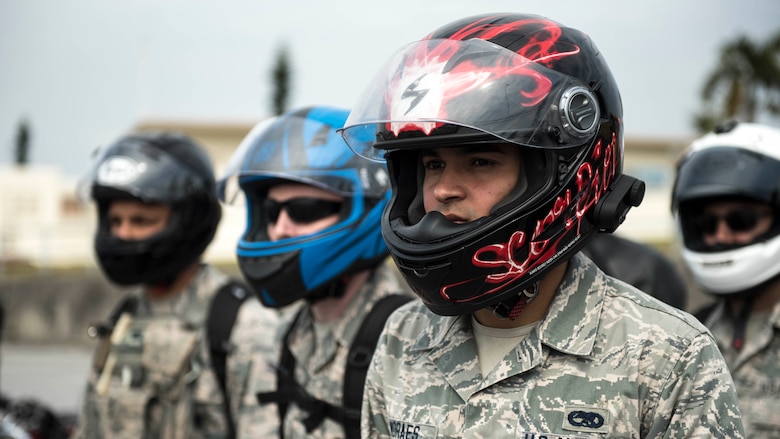 U.S. Air Force Senior Airman Alisson Moraes, motorcycle rider, listens to a skill course brief during an 18th Wing annual motorcycle safety brief March 9, 2017, at Kadena Air Base, Japan. Moraes and other riders stationed on Okinawa reviewed safety regulations and refreshed fundamental riding skills on a course set up by Wing Safety and the Green Knights chapter 138 motorcycle mentorship group. (U.S. Air Force photo by Staff Sgt. Peter Reft/Released)