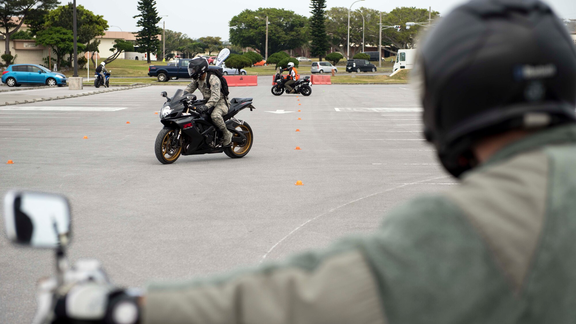 Motorcycle riders refresh their skills on a handling course during an 18th Wing annual motorcycle safety brief March 9, 2017, at Kadena Air Base, Japan. Wing Safety and the Green Knights chapter 138 hosted the event to reinforce safety regulations and help riders test their bike handling skills. (U.S. Air Force photo by Staff Sgt. Peter Reft/Released)
