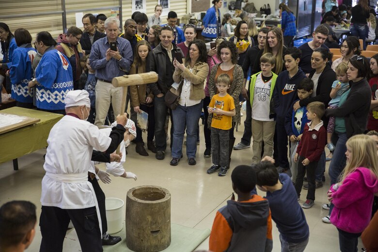 A local Japanese volunteer with the Japanese American Society demonstrates the process of pounding rice, or mochi-tsuki, during the 60th Annual Culture Festival at Marine Corps Air Station Iwakuni, Japan, March 11, 2017. The festival included Japanese dance performances, decorated exhibits and traditional activities and rituals. JAS continues to bridge the U.S.-Japan friendship by providing quality cultural events and activities. (U.S. Marine Corps photo by Lance Cpl. Carlos Jimenez)