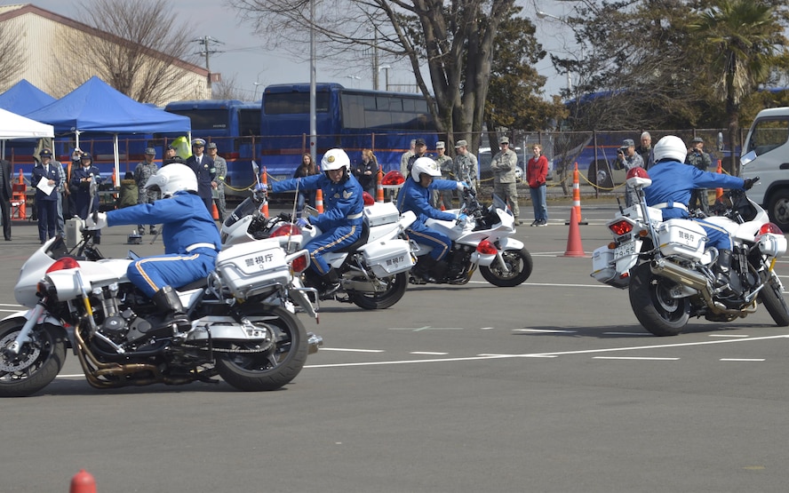 Members from the Tokyo Metro Police Motorcycle Demo team perform during the Yokota Safety and Readiness Festival at Yokota Air Base, Japan, March 10, 2017. The festival held an array of demonstrations and booths to encourage base residents and community members to apply risk management in their daily lives and provide information to assist them. (U.S. Air Force photo by Staff Sgt. David Owsianka)
