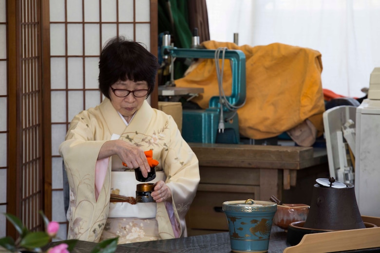 Nakamoto, a Japanese local, demonstrates a traditional Japanese tea ceremony during cultural exchange at Tsuzu Elementary School at Iwakuni City, Japan, March 11, 2017. During the event, a cooking class was held to teach people how to make common Japanese dishes. The event, which brought Americans and Japanese together, taught residents from MCAS Iwakuni about Japanese culture. (U.S. Marine Corps photo by Lance Cpl. Gabriela Garcia-Herrera)
