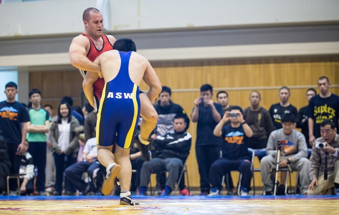 Pfc. Scott Lohndorf, assigned to Headquarters and Headquarters Squadron from Marine Corps Air Station Iwakuni, wrestles his opponent during the 23rd Annual All Japan Self-Defense Force Wrestling Tournament in Camp Asaka, Japan. Lohndorf wrestled with the “Seahawks” Navy Wrestling Team from Fleet Activities Yokosuka. (Courtesy photo by Mass Communication Specialist 1st Class Anthony R. Martinez)