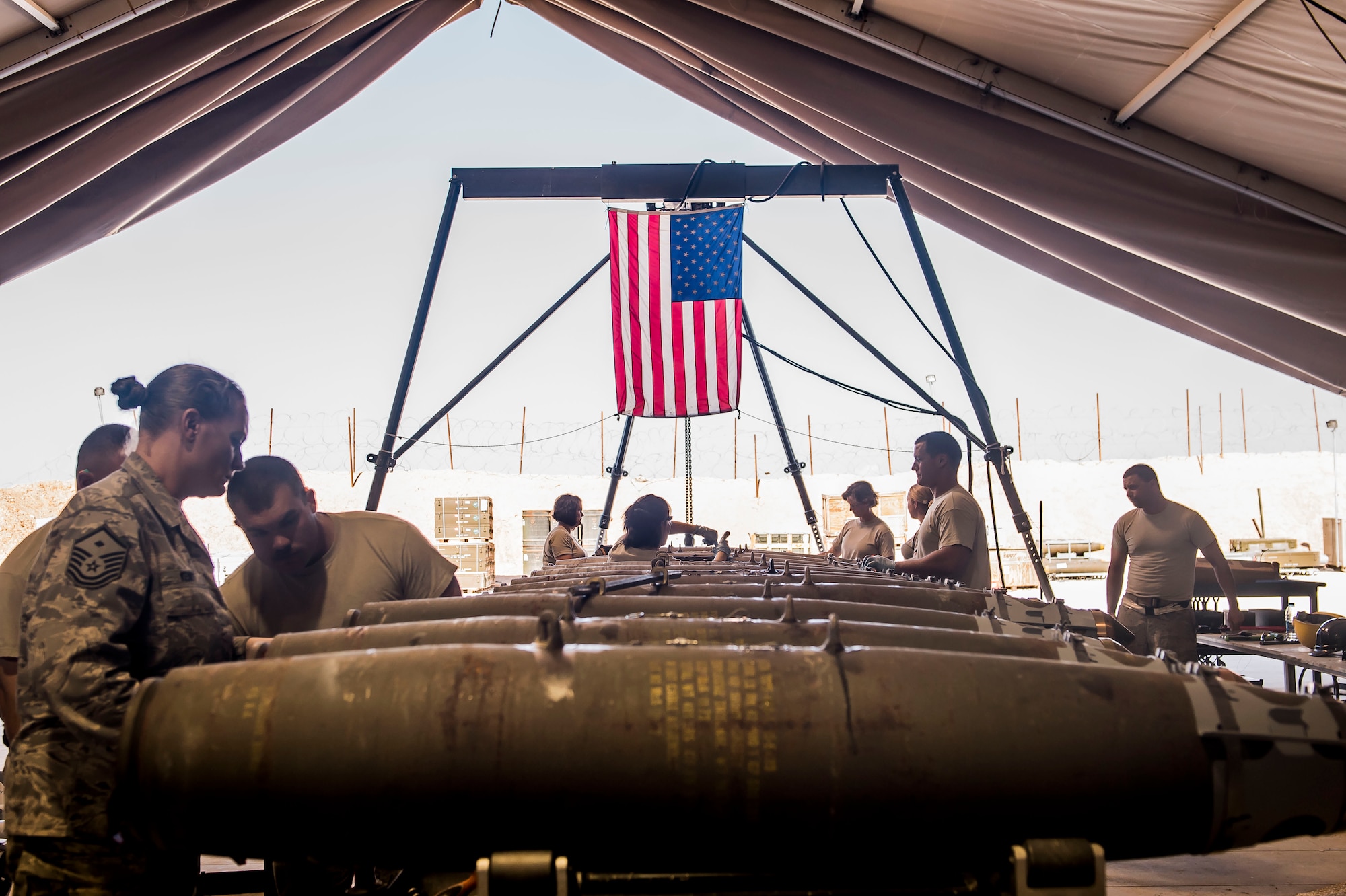 Airmen from the 332nd Expeditionary Maintenance Squadron show female Airmen how to construct a GBU-38 bomb Mar. 7, 2017, in Southwest Asia. The Airmen constructed bombs in honor of Women’s History Month; this year’s theme is ‘Honoring Trailblazing Women in Labor and Business’. (U.S. Air Force photo by Staff Sgt. Eboni Reams)