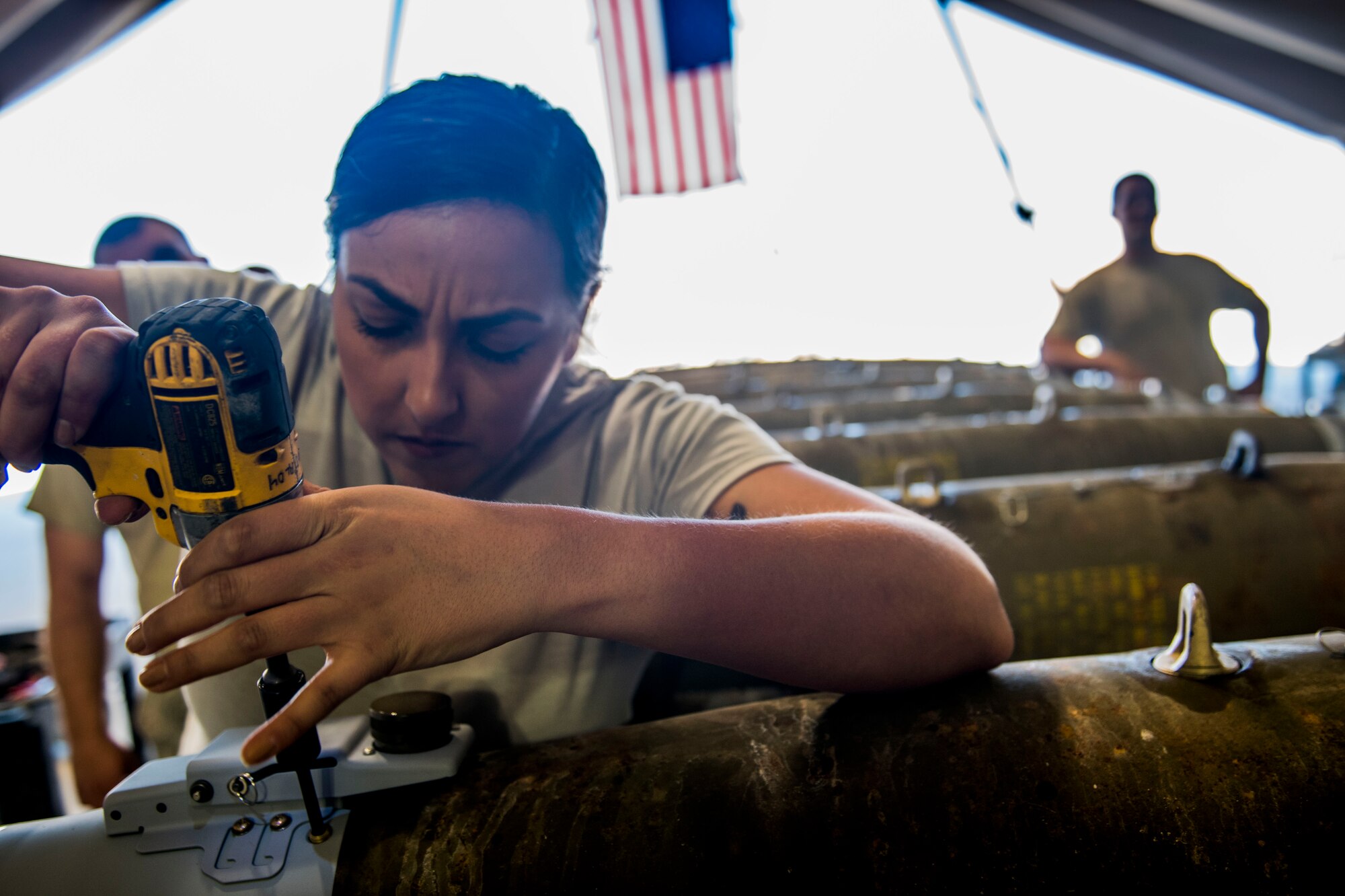Staff Sgt. Elizabeth Silva, 332nd Air Expeditionary Wing command chief executive assistant, drills in a tail fin Mar. 7, 2017, in Southwest Asia. Silva and other Airmen built a dozen GBU-38 bombs in honor of Women’s History Month. (U.S. Air Force photo by Staff Sgt. Eboni Reams)