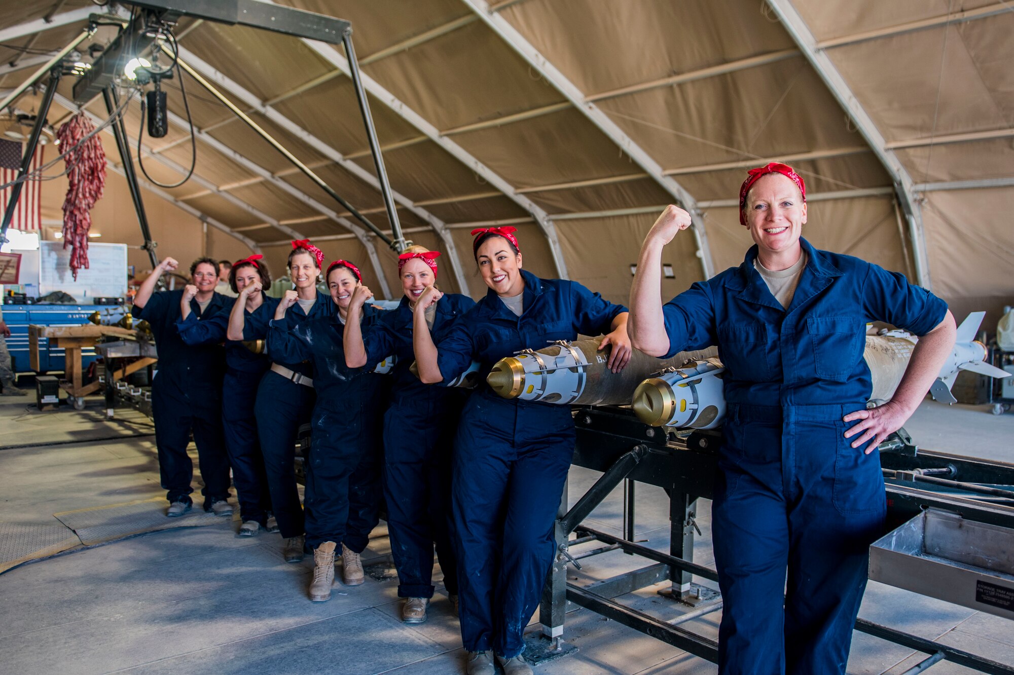 Women dressed as ‘Rosie the Riveter’ pose for a photo with GBU-38 bombs Mar. 7, 2017, in Southwest Asia. These women are Airmen in the U.S. Air Force and built a dozen bombs in honor of Women’s History Month. (U.S. Air Force photo by Staff Sgt. Eboni Reams)