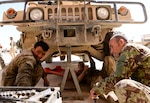 Afghan National Army 215th Corps mechanics work together to repair a Humvee in Helmand Province, Afghanistan, March 11, 2017. Helmand is one of Afghanistan's most contested provinces where maintenance and sustainment support are critical to the fight. (NATO photo by Kay M. Nissen)
