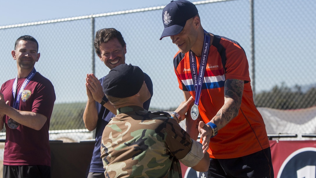 Dutch Lieutenant Col. Enrique Sanchez awards Sgt. Maj. Erik Schujer with a Silver Medal during the 2017 Marine Corps Trials Archery Competition at Marine Corps Base Camp Pendleton, Calif., March 13, 2017. Sanchez and Schujer are members of the 2017 Marine Corps Trials International Team. The Marine Corps Trials promotes recovery and rehabilitation through adaptive sport participation and develops camaraderie among recovering Service members and veterans. It is an opportunity for RSMs to demonstrate their achievements and serves as the primary venue to select Marine Corps participants for the DoD Warrior Games. 