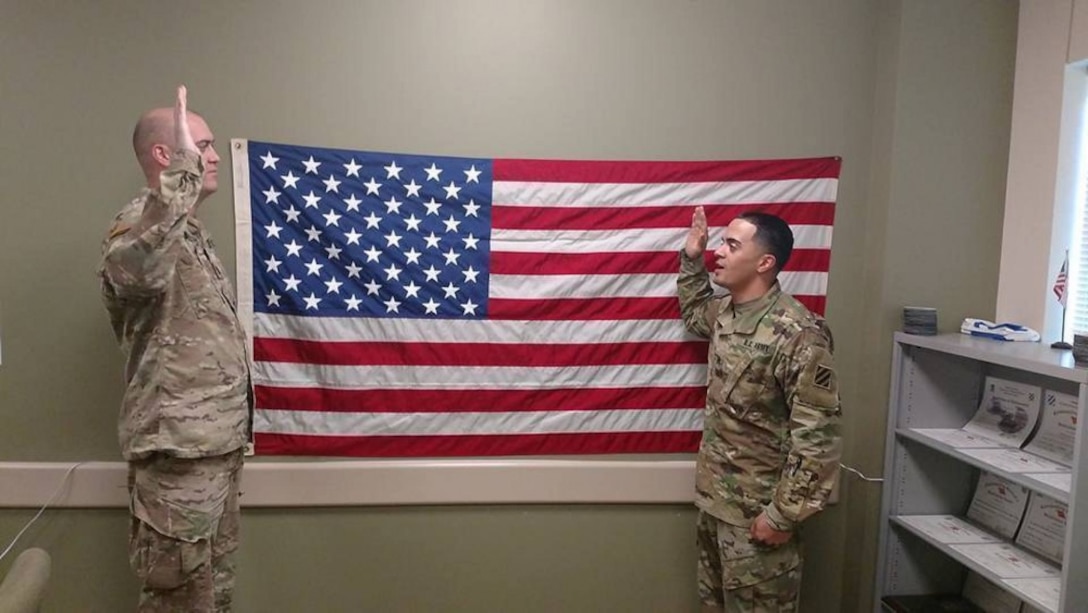 Army Sgt. Angel Cruz, right, multichannel transmission system operator-maintainer with 3rd Battalion, 15th Infantry Regiment, 2nd Infantry Brigade Combat Team, 3rd Infantry Division, recites the oath of re-enlistment at Fort Stewart, Ga., Feb. 15, 2017. Army photo by Spc. Efren Rodriguez