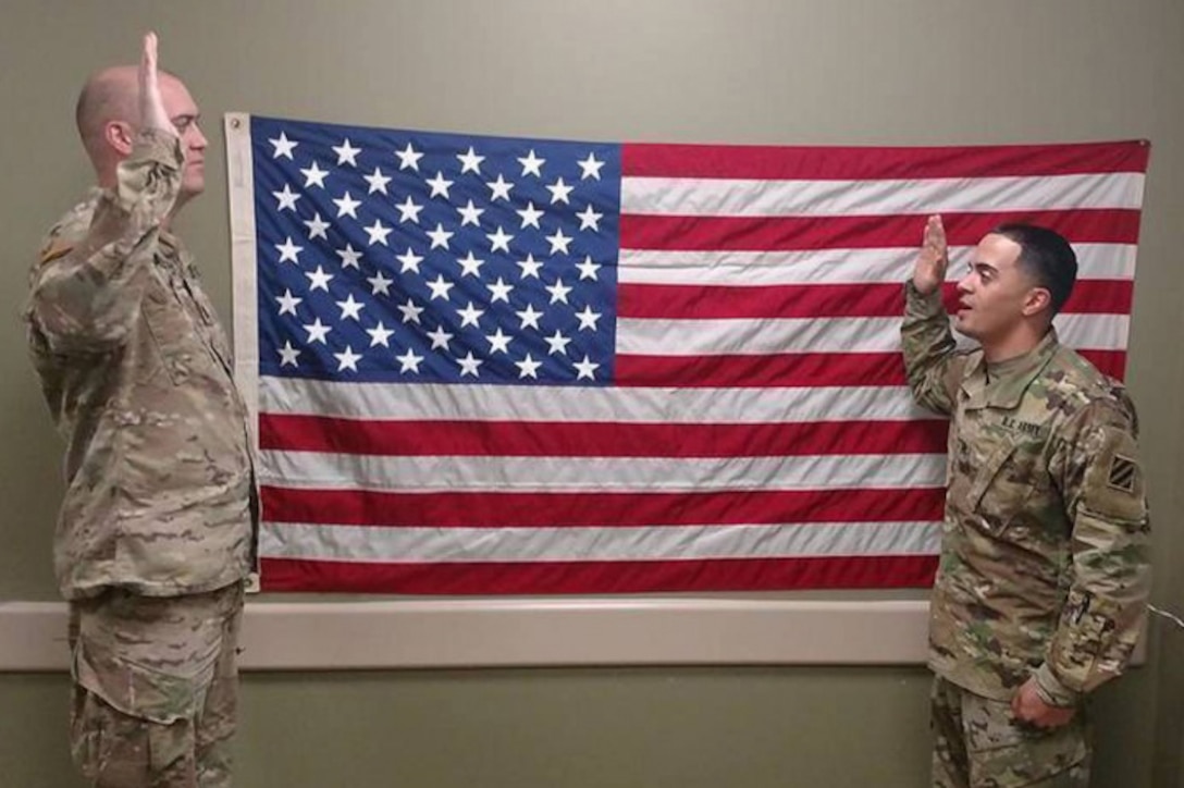 Army Sgt. Angel Cruz, right, multichannel transmission system operator-maintainer with 3rd Battalion, 15th Infantry Regiment, recites the oath of re-enlistment at Fort Stewart, Ga., Feb. 15, 2017. Army photo by Spc. Efren Rodriguez