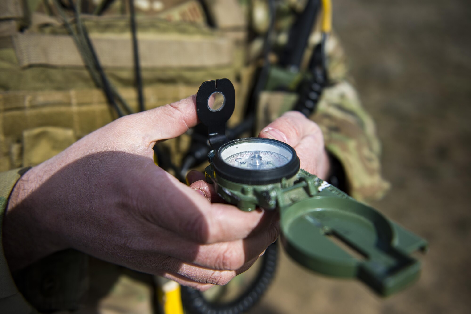Tech. Sgt. Ben Domain, a Survival, Evasion, Resistance, and Escape (SERE) specialists with the 308th Rescue Squadron, checks a compass before marking a landing zone for pararescuemen parachuting out of a HC-130J Combat King II, March 2, 2017, at the Orchard Combat Training Center in Idaho, during pre-deployment training for the 305th Rescue Squadron. The 305th RQS, located at Davis-Monthan Air Force Base, Ariz., is conducting training at the Idaho Air National Guard’s Orchard Combat Training Center, a 143,000-acre live-fire range located south of Boise, Idaho, to hone all of their search and rescue procedures before heading to Southwest Asia. (U.S. Air Force photo/Staff Sgt. Jared Trimarchi)