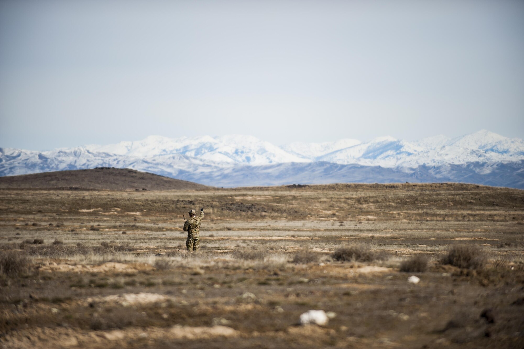 Tech. Sgt. Ben Domain, a Survival, Evasion, Resistance, and Escape (SERE) specialists with the 308th Rescue Squadron, checks wind direction on a landing zone for pararescuemen parachuting out of a HC-130J Combat King II, March 2, 2017, at the Orchard Combat Training Center in Idaho, during pre-deployment training for the 305th Rescue Squadron. The 305th RQS, located at Davis-Monthan Air Force Base, Ariz., is conducting training at the Idaho Air National Guard’s Orchard Combat Training Center, a 143,000-acre live-fire range located south of Boise, Idaho, to hone all of their search and rescue procedures before heading to Southwest Asia. (U.S. Air Force photo/Staff Sgt. Jared Trimarchi)
