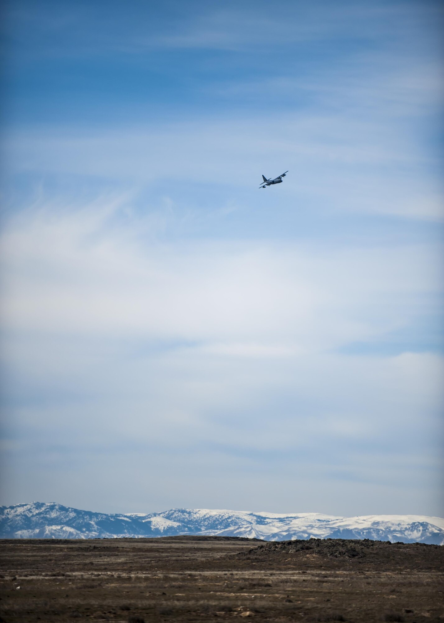A HC-130J Combat King II, from the 79th Rescue Squadron, soars above a mountain range, March 2, 2017, at the Orchard Combat Training Center in Idaho, during pre-deployment training for the 305th Rescue Squadron. The 305th RQS, located at Davis-Monthan Air Force Base, Ariz., is conducting training at the Idaho Air National Guard’s Orchard Combat Training Center, a 143,000-acre live-fire range located south of Boise, Idaho, to hone all of their search and rescue procedures before heading to Southwest Asia. (U.S. Air Force photo/Staff Sgt. Jared Trimarchi)