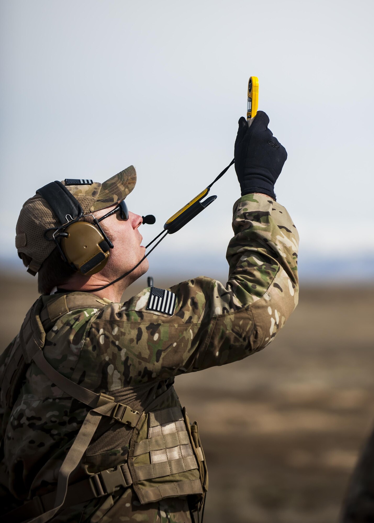 Tech. Sgt. Ben Domain, a Survival, Evasion, Resistance, and Escape (SERE) specialists with the 308th Rescue Squadron, checks winds speed on a landing zone for pararescuemen parachuting out of a HC-130J Combat King II, March 2, 2017, at the Orchard Combat Training Center in Idaho, during pre-deployment training for the 305th Rescue Squadron. The 305th RQS, located at Davis-Monthan Air Force Base, Ariz., is conducting training at the Idaho Air National Guard’s Orchard Combat Training Center, a 143,000-acre live-fire range located south of Boise, Idaho, to hone all of their search and rescue procedures before heading to Southwest Asia. (U.S. Air Force photo/Staff Sgt. Jared Trimarchi)