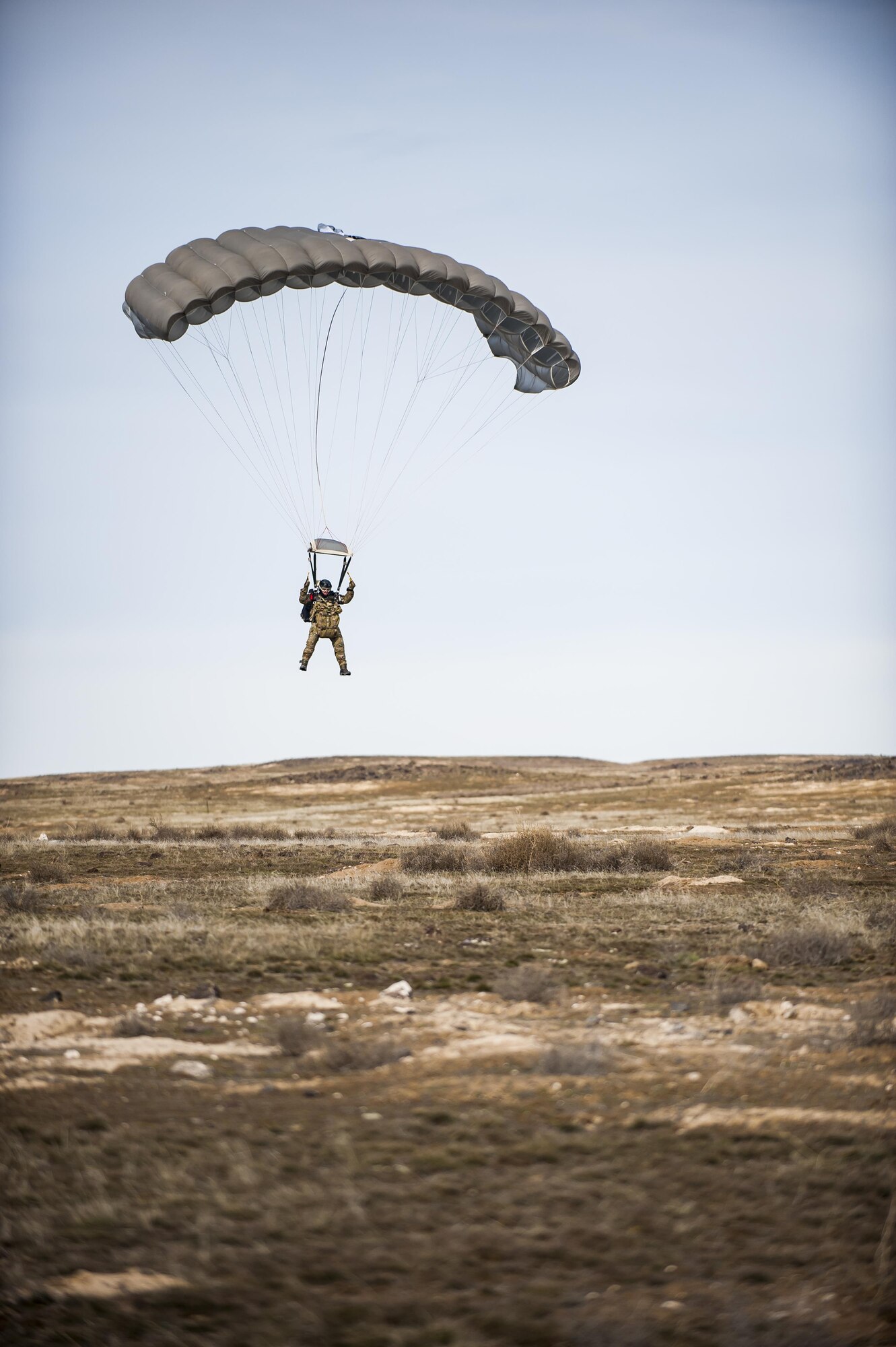 A pararescueman with the 308th Rescue Squadron, controls his parachute before landing on the ground, March 2, 2017, at the Orchard Combat Training Center in Idaho, during pre-deployment training for the 305th Rescue Squadron. The 305th RQS, located at Davis-Monthan Air Force Base, Ariz., is conducting training at the Idaho Air National Guard’s Orchard Combat Training Center, a 143,000-acre live-fire range located south of Boise, Idaho, to hone all of their search and rescue procedures before heading to Southwest Asia. (U.S. Air Force photo/Staff Sgt. Jared Trimarchi)