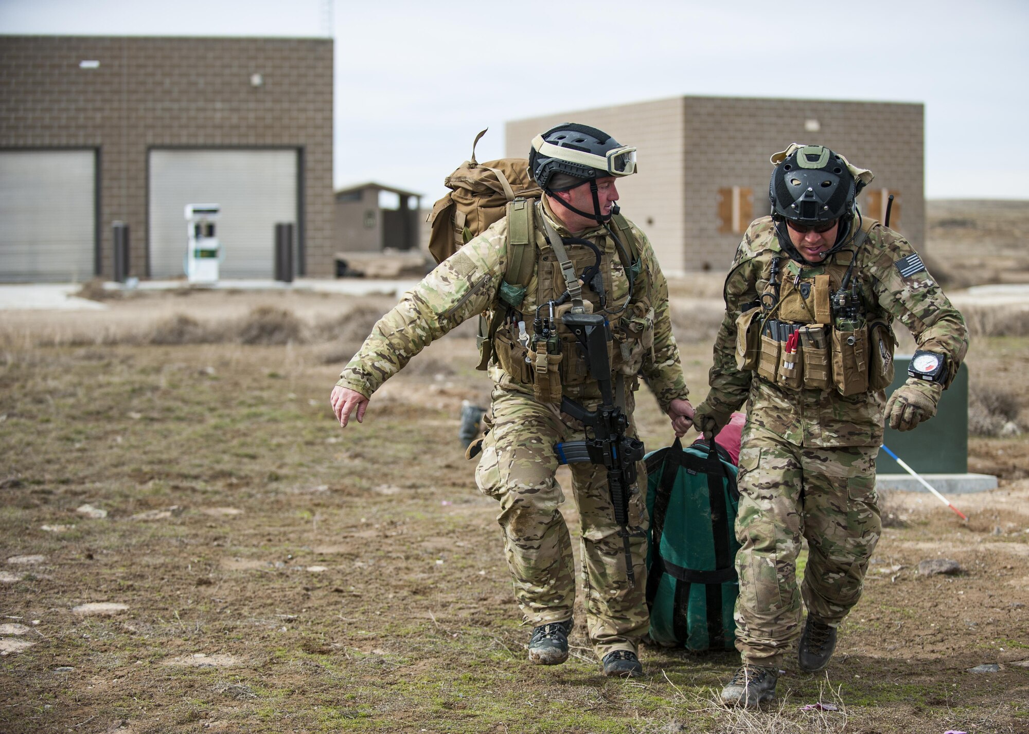 Two pararescueman, from the 308th Rescue Squadron, drag a simulated patient to safety, March 2, 2017, at the Orchard Combat Training Center in Idaho, during pre-deployment training for the 305th Rescue Squadron. The 305th RQS, located at Davis-Monthan Air Force Base, Ariz., is conducting training at the Idaho Air National Guard’s Orchard Combat Training Center, a 143,000-acre live-fire range located south of Boise, Idaho, to hone all of their search and rescue procedures before heading to Southwest Asia. (U.S. Air Force photo/Staff Sgt. Jared Trimarchi)