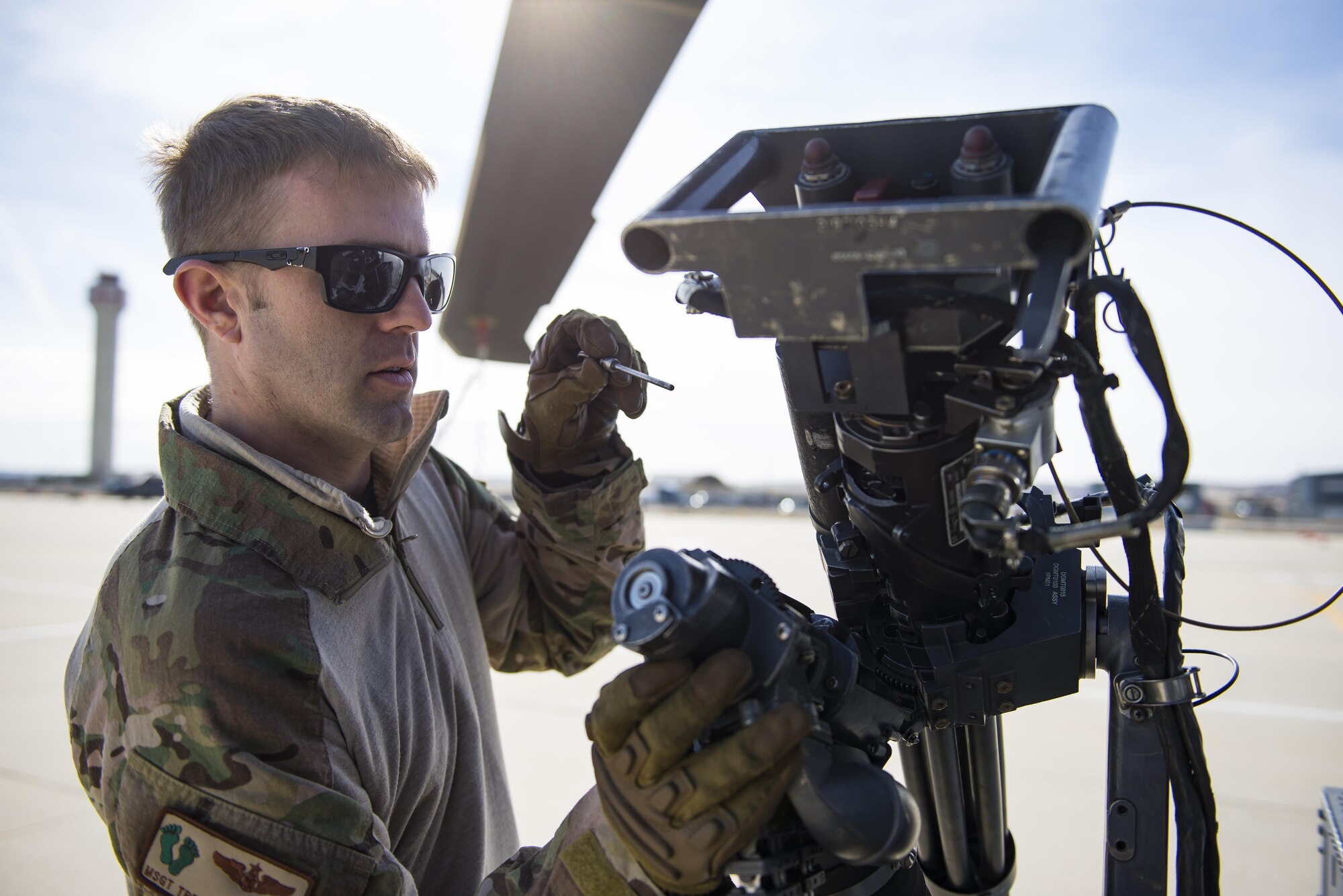 Master Sgt. Trevor Stevens, an evaluator flight engineer from the 943rd Rescue Group, inspects an M134 minigun attached to a HH-60G Pave Hawk helicopter, March 3, 2017, at Gowen Field, Idaho, during pre-deployment training for the 305th Rescue Squadron. The 305th RQS, located at Davis-Monthan Air Force Base, Ariz., is conducting training at the Idaho Air National Guard’s Orchard Combat Training Center, a 143,000-acre live-fire range located south of Boise, Idaho, to hone all of their search and rescue procedures before heading to Southwest Asia. (U.S. Air Force photo/Staff Sgt. Jared Trimarchi)