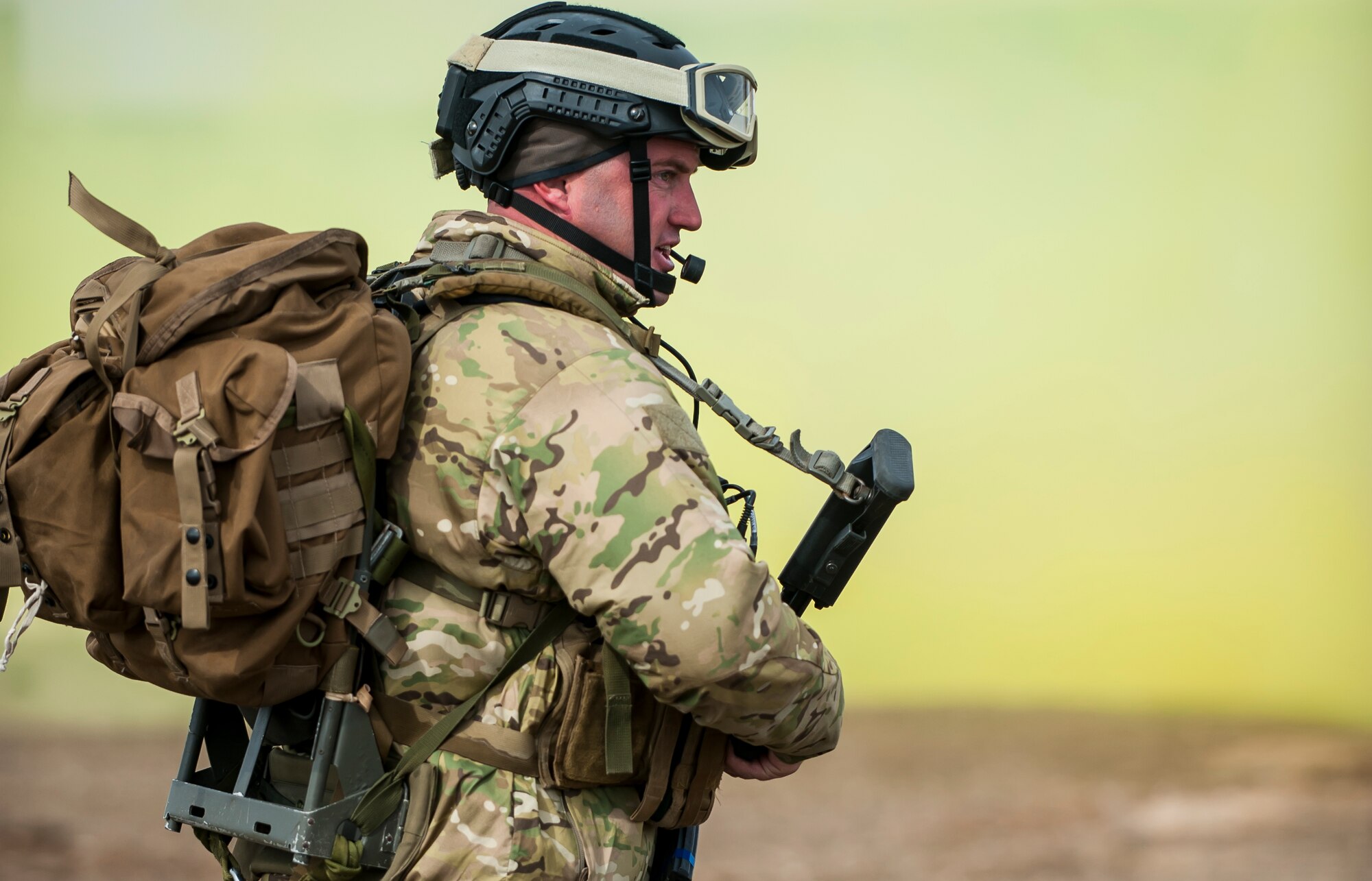 Tech. Sgt. Louis Hause, a pararescueman with the 308th Rescue Squadron, awaits a helicopter exfiltration in-front of a screen of yellow smoke, March 2, 2017, at the Orchard Combat Training Center in Idaho, during pre-deployment training for the 305th Rescue Squadron. The 305th RQS, located at Davis-Monthan Air Force Base, Ariz., is conducting training at the Idaho Air National Guard’s Orchard Combat Training Center, a 143,000-acre live-fire range located south of Boise, Idaho, to hone all of their search and rescue procedures before heading to Southwest Asia. (U.S. Air Force photo/Staff Sgt. Jared Trimarchi)