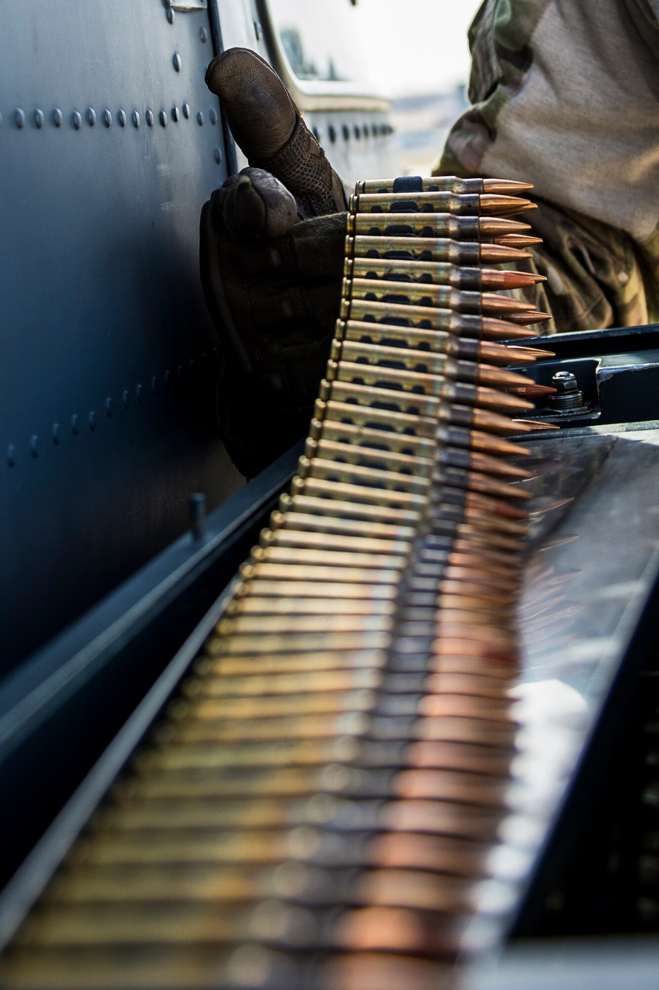 Master Sgt. Trevor Stevens, from the 943rd Rescue Group, checks the 7.62 mm rounds for an M134 minigun attached to a HH-60G Pave Hawk helicopter, March 3, 2017, at Gowen Field, Idaho, during pre-deployment training for the 305th Rescue Squadron. The 305th RQS, located at Davis-Monthan Air Force Base, Ariz., is conducting training at the Idaho Air National Guard’s Orchard Combat Training Center, a 143,000-acre live-fire range located south of Boise, Idaho, to hone all of their search and rescue procedures before heading to Southwest Asia. (U.S. Air Force photo/Staff Sgt. Jared Trimarchi)