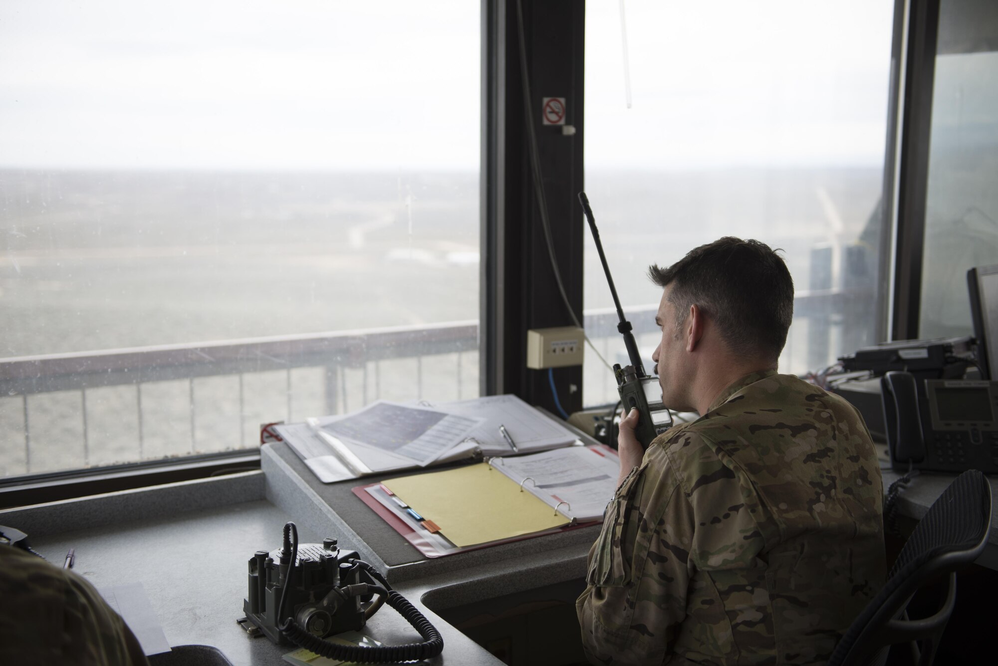 Lt. Col. Chris Escajeda, the training’s Pave Hawk mission lead, contacts an HH-60G Pave Hawk helicopter aircrew above a tower, March 3, 2017, at the Orchard Combat Training Center in Idaho, during pre-deployment training for the 305th Rescue Squadron. The 305th RQS, located at Davis-Monthan Air Force Base, Ariz., is conducting training at the Idaho Air National Guard’s Orchard Combat Training Center, a 143,000-acre live-fire range located south of Boise, Idaho, to hone all of their search and rescue procedures before heading to Southwest Asia. (U.S. Air Force photo/Staff Sgt. Jared Trimarchi)