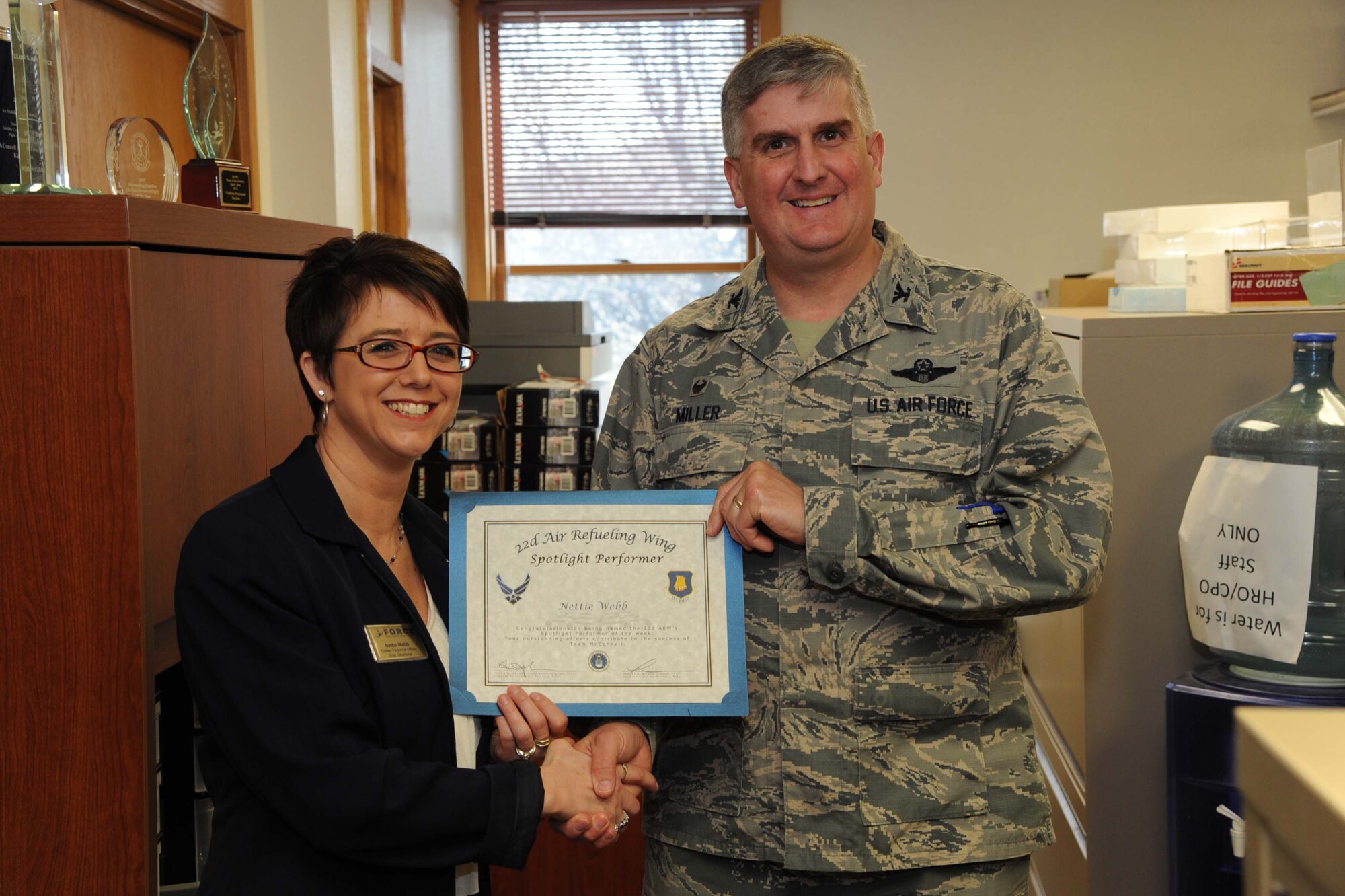 Nettie Webb, 22nd Force Support Squadron civilian personnel officer, poses with Col. Albert Miller, 22nd Air Refueling Wing commander, March 9, 2017, at McConnell Air Force Base, Kan. Webb received the spotlight performer for the week of Jan. 30 – Feb. 3. (U.S. Air Force photo/Airman 1st Class Jenna K. Caldwell)  