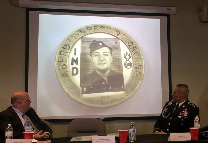 Cartoonist Will Eisner, shown on projection screen, would have been 100 years old on March 6, 2017. After being drafted in 1942, Eisner was assigned to the camp newspaper at Aberdeen Proving Ground, also 100 years old this year. Army photo by Rick Scavetta