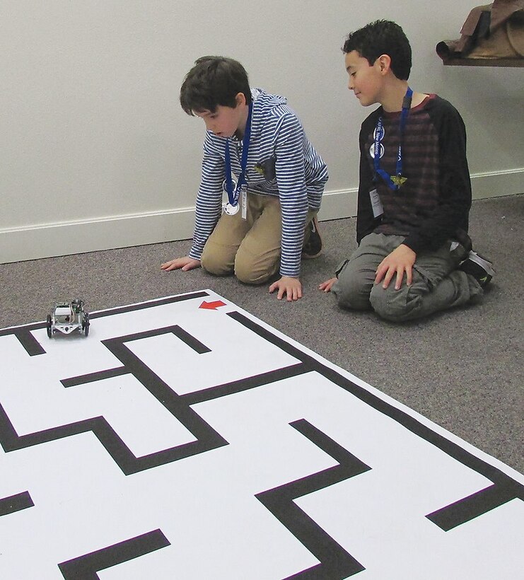 Kieran Ercolino and Kieran Vollmar from the New Mexico School for the Deaf prepare their robot for the practice course of the black maze during the Air Force Research Laboratory La Luz Academy’s Robotics Challenge Expo on March 2 at Kirtland Air Force Base.