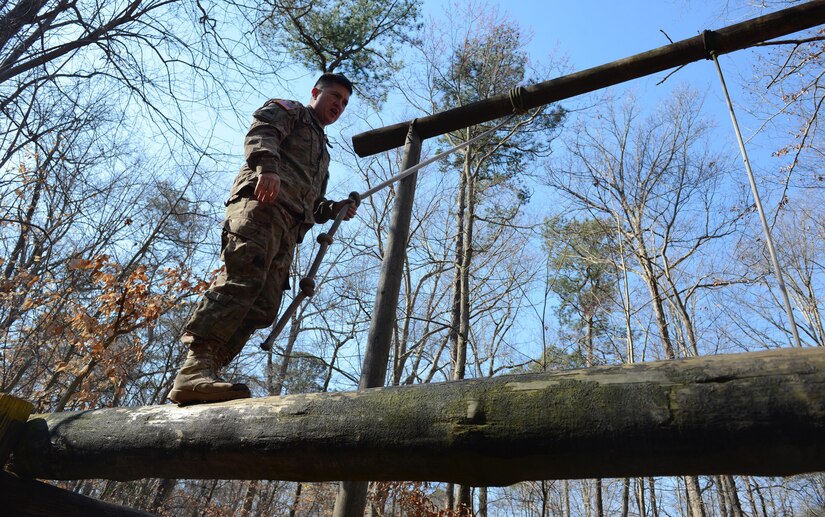 U.S. Army Sgt. David Applegate, Charlie Company, 210th Aviation Regiment, 128th Aviation Brigade instructor and NCO of the Year competitor, uses a rope to swing onto a raised log during the NCO and Advanced Individual Training Platoon Sergeant of the Year Competition at Joint Base Langley-Eustis, Va., March 6, 2017. The Soldiers performed various challenges throughout the competition, such as obstacle courses, physical fitness tests, written exams and simulated combat situations to challenge them both physically and mentally. (U.S. Air Force photo/Airman 1st Class Kaylee Dubois)