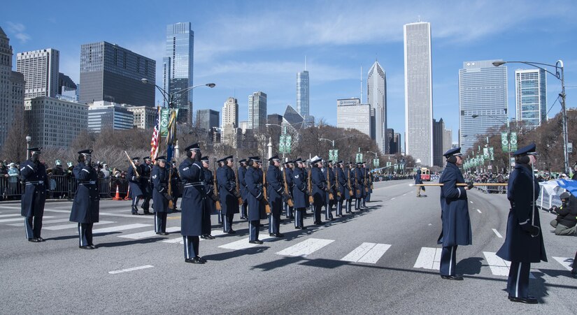 The U.S. Air Force Honor Guard perform drill movements in front of a reviewing stand during the annual Chicago St. Patrick’s Day Parade, March 11, 2017. In preparation for the parade, the team practiced their formation by marching a mock parade route around their compound in addition to training five days a week and performing ceremonies on a regular basis. (U.S. Air Force photo by Senior Airman Jordyn Fetter)