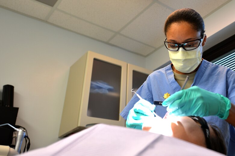 U.S. Air Force Major Rachael Parrish, 20th Dental Squadron general dentist, performs an oral exam on Airman 1st Class Amie Bickford, 20th Equipment Maintenance Squadron munitions technician at Shaw Air Force Base, S.C., March 13, 2017. Airmen assigned to the 20th DS are tasked with ensuring Airmen and soldiers on base meet all dental class requirements for deployment. (U.S. Air Force photo by Airman 1st Class Christopher Maldonado)