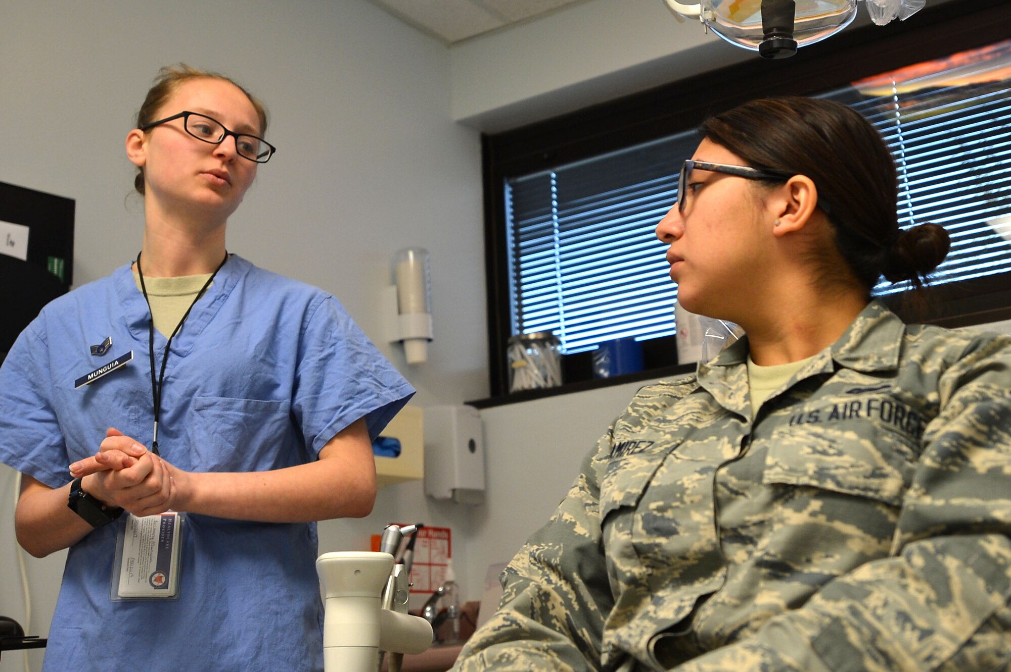 U.S. Air Force Senior Airman Brittany Munguia, 20th Dental Squadron dental technician, left, counsels Airman 1st Class Mariah Ramirez, 20th Logistics Readiness Squadron equipment accountability technician, right, at Shaw Air Force Base, S.C., March 13, 2017. Along with oral screenings, Airmen assigned to the 20th DS counsel Airmen who may be approaching oral surgeries, providing tips for success. (U.S. Air Force photo by Airman 1st Class Christopher Maldonado)