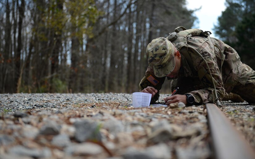 U.S. Army Staff Sgt. Randie Bobb, Alpha Company, 210th Aviation Regiment, 128th Aviation Brigade instructor and NCO of the Year competitor, plots points on a map to locate his target destination during the NCO and Advanced Individual Training Platoon Sergeant of the Year Competition at Joint Base Langley-Eustis, Va., March 6, 2017. Under time constraints, the Soldiers were challenged to find eight targets within a six-mile radius. (U.S. Air Force photo/Airman 1st Class Kaylee Dubois)