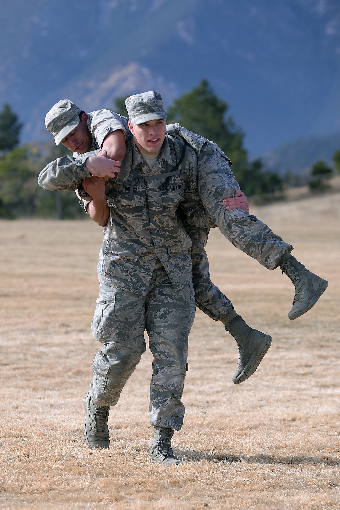 A freshman cadet at the U.S. Air Force Academy, Colorado,uses the "fireman's carry" to carry another freshman March 10, 2017 during Recognition. Recognition is a rigorous annual event freshmen or "four degrees" must overcome before earning the title of cadet. (U.S. Air Force photo/Darcie Ibidapo)