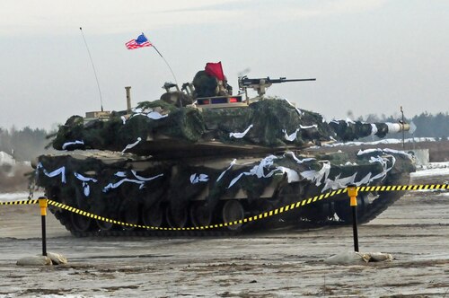 An American M1A2 Abrams tank moves into firing position during a live-fire training exercise at Karlikie Range in Zagan, Poland, Jan. 30, 2017. American forces arrived in Poland in January to begin a nine-month “heel-to-toe” rotation to bolster ties with NATO allies. Army photo by Staff Sgt. Corinna Baltos
