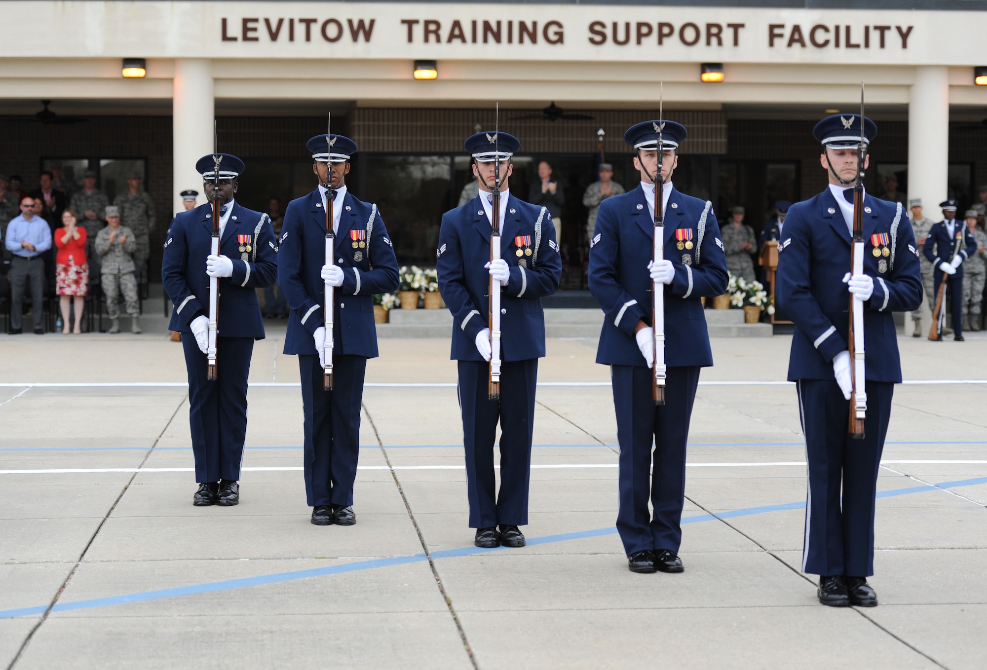 The U.S. Air Force Honor Guard Drill Team debuts their 2017 routine during the 81st Training Group drill down at the Levitow Training Support Facility drill pad March 10, 2017, on Keesler Air Force Base, Miss. The team comes to Keesler every year for five weeks to develop a new routine that they will use throughout the year. (U.S. Air Force photo by Kemberly Groue)