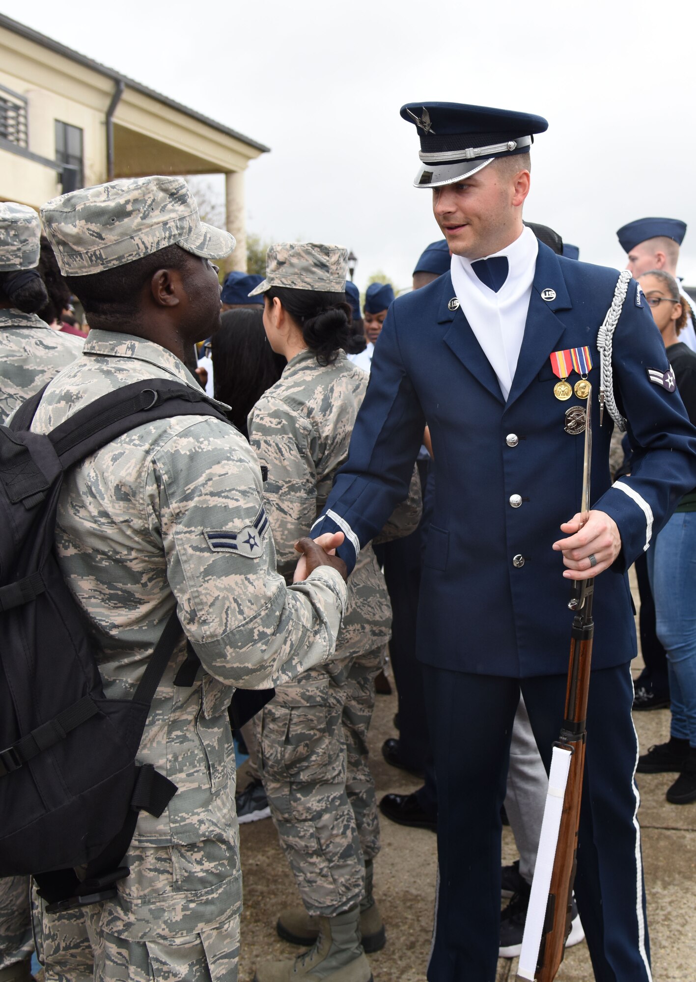 Airman 1st Class Emmanuel Agyemang Duah, 335th Training Squadron student, meets Airman 1st Class Caleb Gothard, U.S. Air Force Honor Guard Drill Team member, following the debut performance of the team’s 2017 routine during the 81st Training Group drill down at the Levitow Training Support Facility drill pad March 10, 2017, on Keesler Air Force Base, Miss. The team comes to Keesler every year for five weeks to develop a new routine that they will use throughout the year. (U.S. Air Force photo by Kemberly Groue)