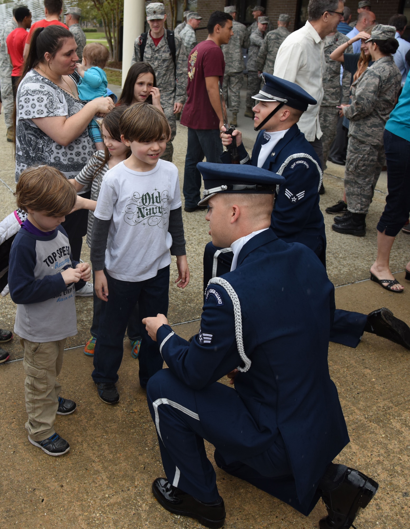 Senior Airmen Jacob Wilson and Scott Gricius, U.S. Air Force Honor Guard Drill Team members, meet with Keesler families following the debut performance of their 2017 routine during the 81st Training Group drill down at the Levitow Training Support Facility drill pad March 10, 2017, on Keesler Air Force Base, Miss. The team comes to Keesler every year for five weeks to develop a new routine that they will use throughout the year. (U.S. Air Force photo by Kemberly Groue)