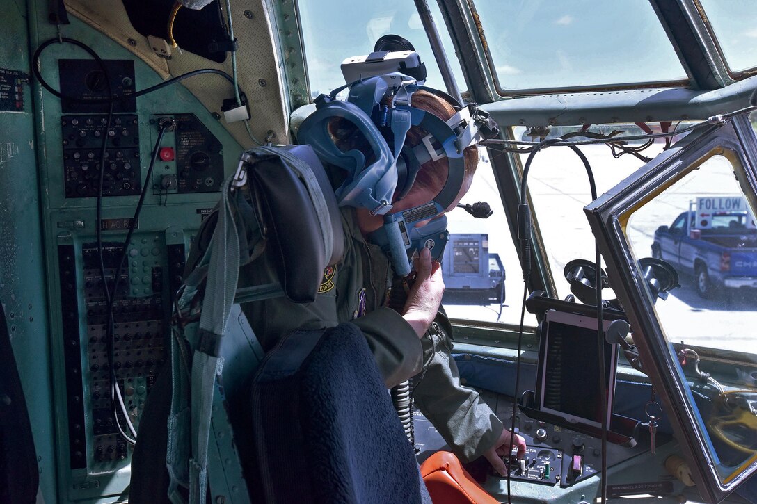 Puerto Rico Air National Guard Maj. Isbelia Reyes checks an oxygen regulator inside a C-130 Hercules before a flight mission to commemorate International Women's Day at Muñiz Air National Guard Base, Puerto Rico, March 8, 2017. Air National Guard photo by Staff Sgt. Angel Oquendo