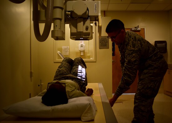 U.S. Air Force Airman 1st Class John Dennis, 633rd Surgical Operations Squadron diagnostics imaging technologist, performs an x-ray on a patient, at Joint Base Langley-Eustis, Va., Feb. 21, 2017. Airmen assigned to the 633rd SGCS radiology department are equipped with the technology needed to provide images, assisting doctors in performing diagnosis and giving trusted care to patients in the medical clinic, surgical department and emergency room, 24 hours a day. (U.S. Air Force photo/Senior Airman Areca T. Bell) 