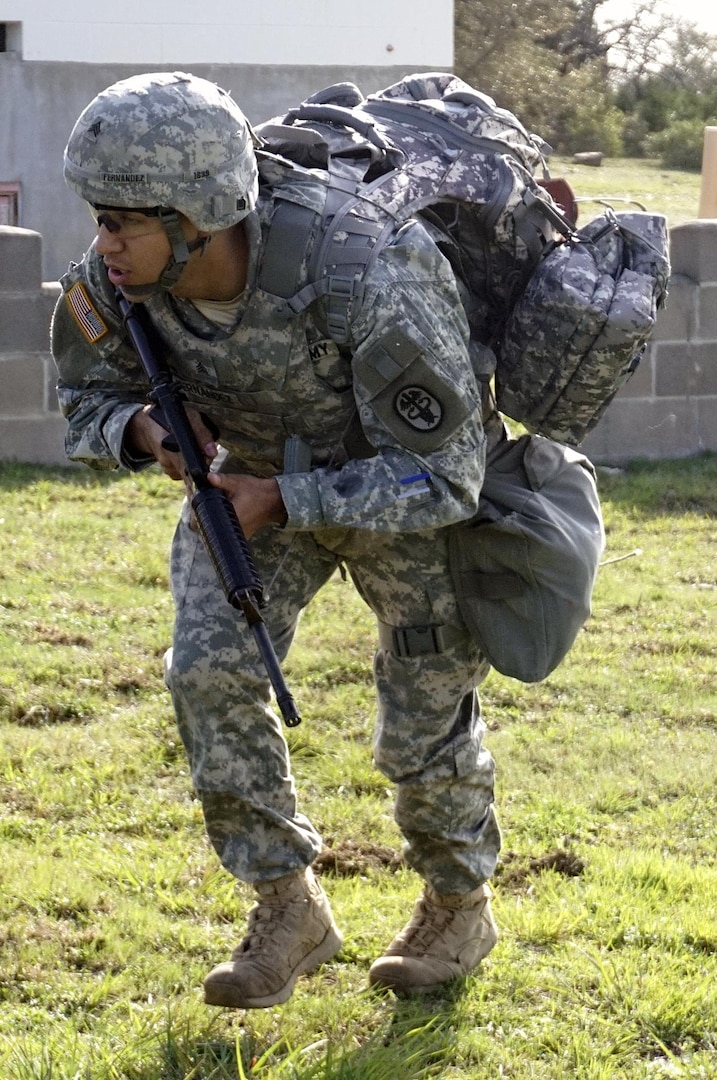Sgt. Juan Fernandez, Fort Bliss Dental Activity, uses the five-second rush to seek cover under fire during Army Warrior Task Lane during the Regional Best Warrior Competition hosted by the Joint Base San Antonio-Fort Sam Houston Dental Health Activity, or DENTAC, from Feb. 27 to March 3 at JBSA-Camp Bullis .