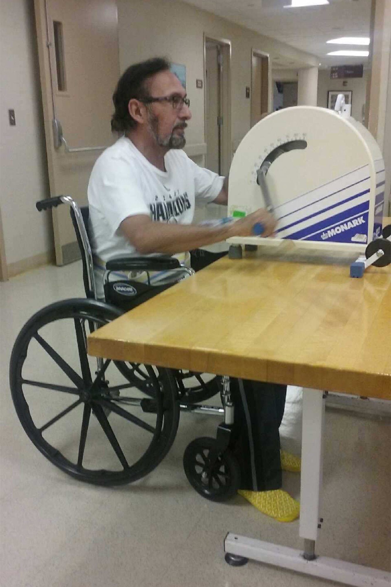 Victor Villerreal, 21st Force Support Squadron Air Force Aid Society officer, exercises on an arm bike July 2016 at St. Luke’s Baptist Hospital, after suffering a massive stroke. The arm bike helped to improve range of motion in his left arm and hand. (Courtesy photo)