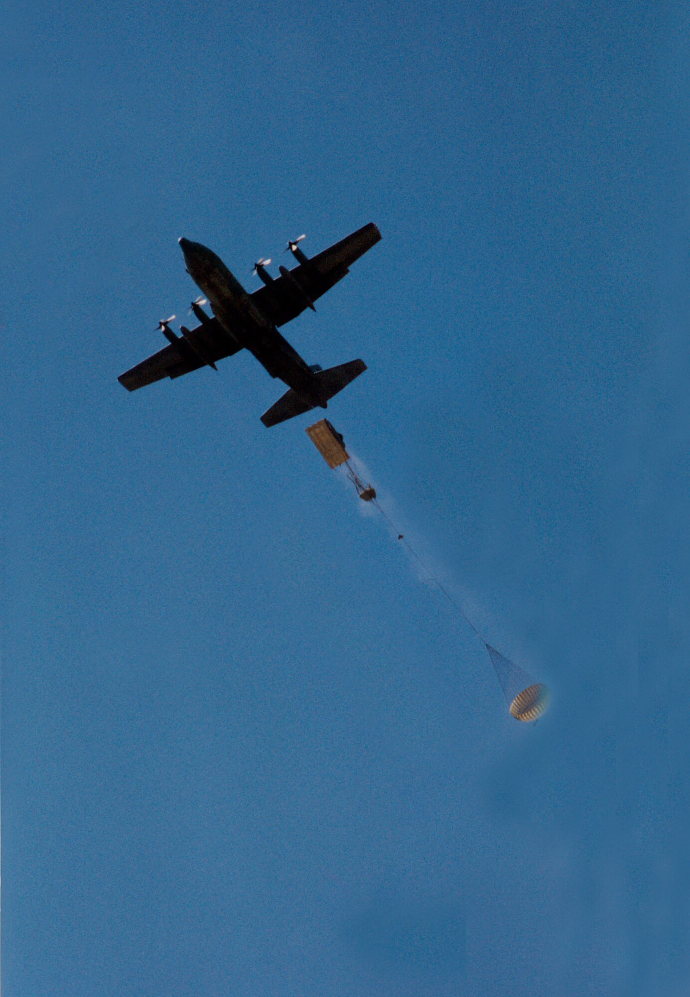 One of the 908th Air Lift Wing's eight C-130 Hercules aircraft practices dropping supplies on Maxwell Air Force Base. (U.S. Air Force photo by Lt. Col. Jerry Lobb)