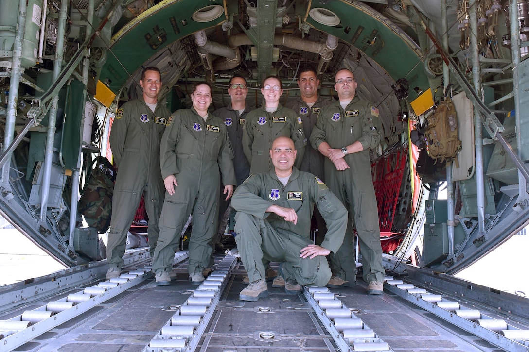 Puerto Rico Air National Guard Maj. Isbelia Reyes, second from left, aircraft commander; Capt. Heather Kindred, center; and the flight crew pose for a photo before a mission to commemorate International Women's Day at Muñiz Air National Guard Base, Puerto Rico, March 9, 2017. Air National Guard photo by Master Sgt. Edgar Morell