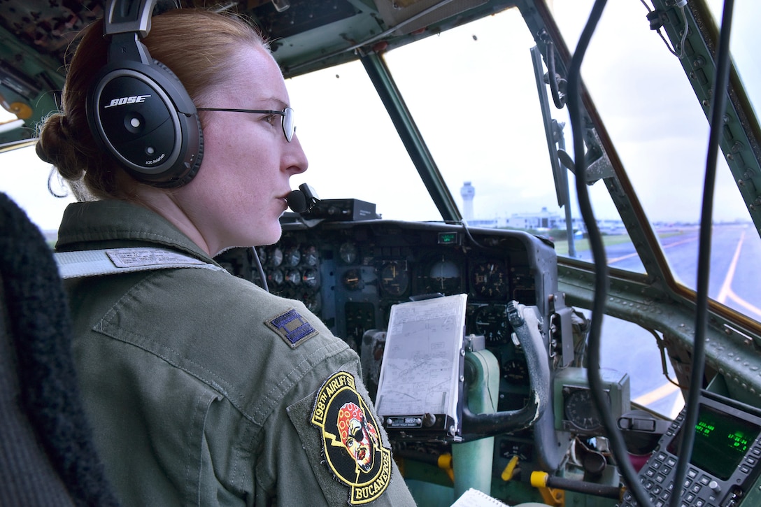 Puerto Rico Air National Guard Capt. Heather Kindred talks to the air traffic control tower from the flightline before a mission to commemorate International Women's Day at Muñiz Air National Guard Base, Puerto Rico, March 9, 2017. Kindred is a pilot assigned to the 156th Airlift Wing. Air National Guard photo by Master Sgt. Edgar Morell