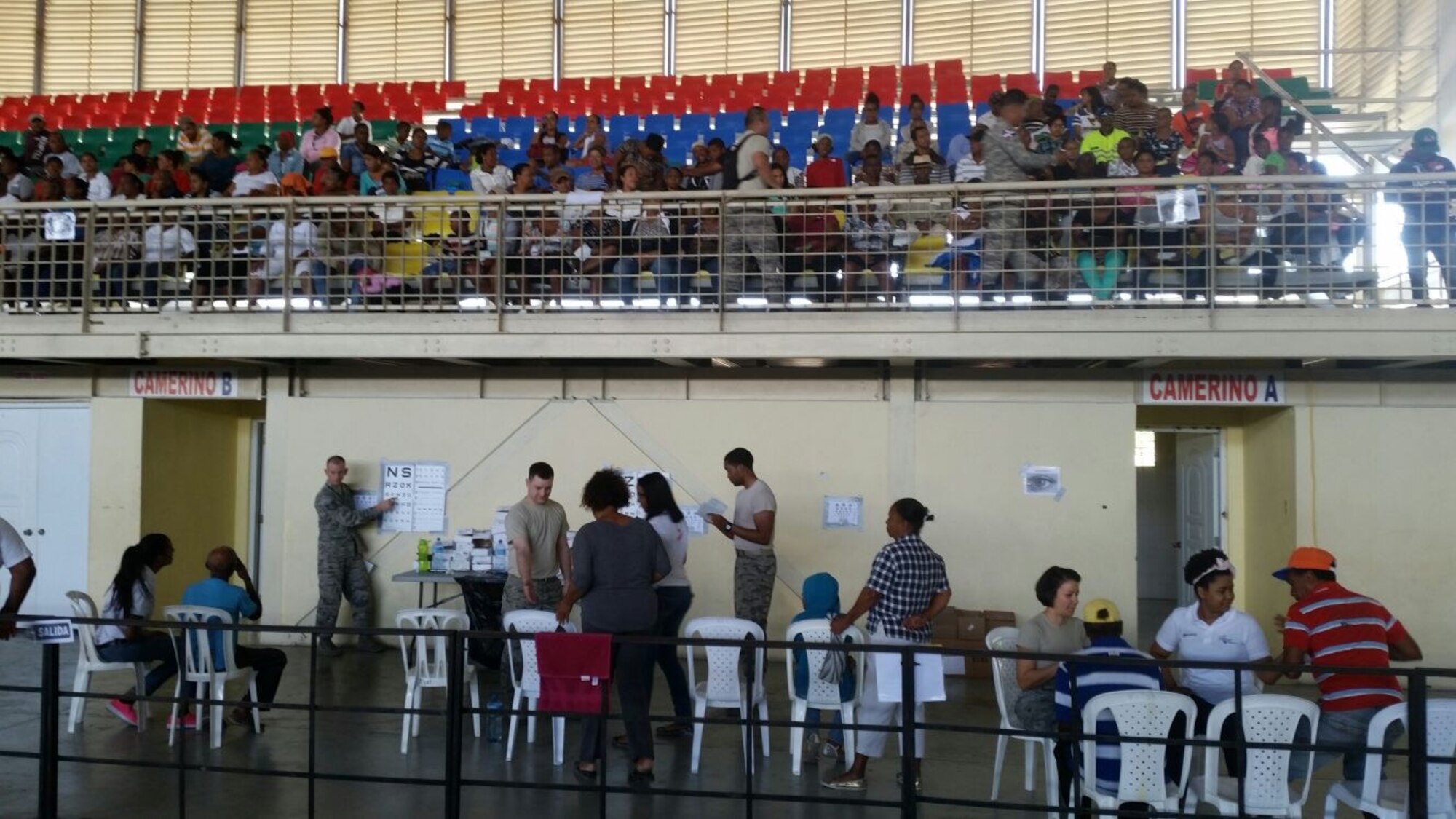Staff Sgt. Dwain Tolbert, right rear, and Senior Airman Todd Stout, center left, 21st MDG optometry technicians, assist patients in Azua, Dominican Republic during Operation New Horizons, an exercise run by Air Force South, March 3-18, 2017. A team from 21st Medical Group, Peterson Air Force Base, Colo., is leading the initial phase of the exercise for the first time since the operation began in 2008. (Courtesy photo)