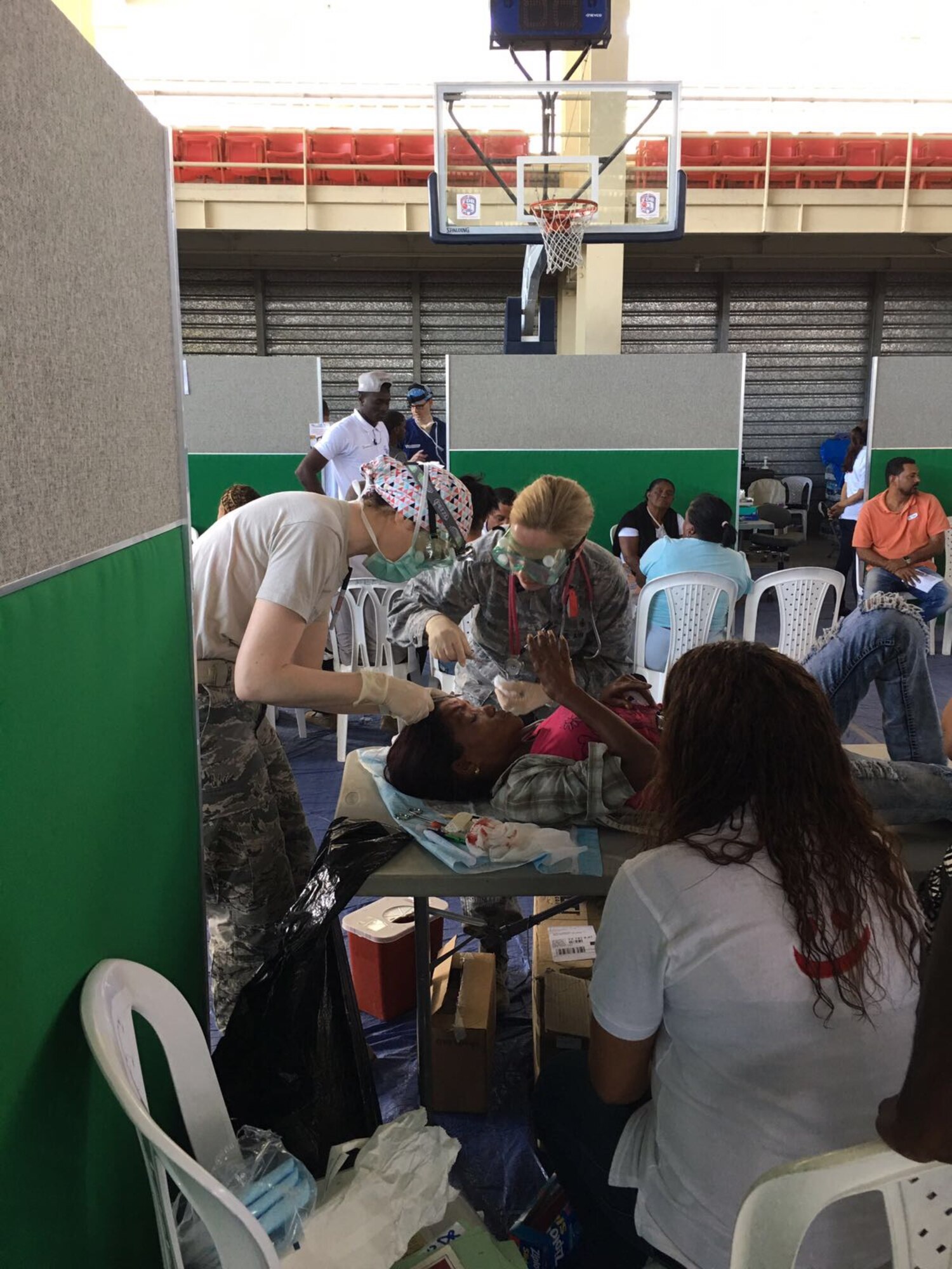 Capt. Natasha Lewis, 21st Medical Group nurse, stitches a patient during in Azua, Dominican Republic during Operation New Horizons, an exercise run by Air Force South, March 3-18, 2017. A group from 21st Medical Group, Peterson Air Force Base, Colo., is leading the initial phase of the exercise for the first time since the operation began in 2008. (Courtesy photo)