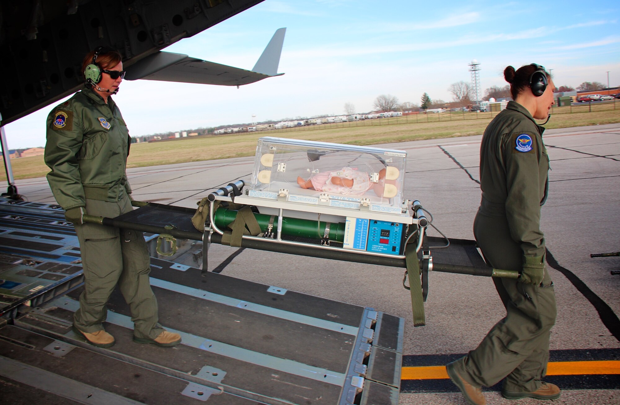 The 349th Air Mobility Wing provided a C-17A Globemaster to move 932nd Aeromedical Evacuation Squadron members during an off station trainer flight.  This gave both the C-17 aircrews and local aeromedical personnel a chance to work together while in the air, perfecting their medical skills training.  Upon return arrival at Scott Air Force Base on March 14, 2017, the small "patient" is carried carefully off the plane by 932nd Aeromedical Evacuation Squadron staff.  The simulated baby seen here, plays the part of a "patient" during the recent scenario to increase cooperation between air and ground staff, who helped to off load her from the visiting C-17.  The 349th Air Mobility Wing, located at Travis Air Force Base, Calif., is the largest associate wing in the U.S. Air Force Reserve Command. (U.S. Air Force photo by Lt. Col. Stan Paregien) 