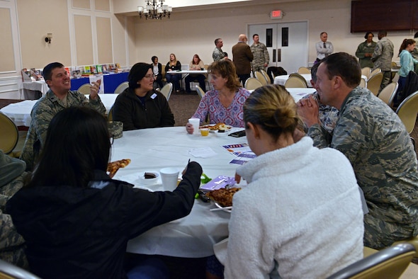 Maggie Catoe, 20th Medical Support Squadron key spouse mentor, center left, speaks with individuals from her squadron during a pre-deployment dinner at the Carolina Skies and Conference Center at Shaw Air Force Base, S.C., March 13, 2017. Key spouses help welcome families to Team Shaw and act as liaisons between spouses and helping agencies. (U.S. Air Force photo by Airman 1st Class Destinee Sweeney)